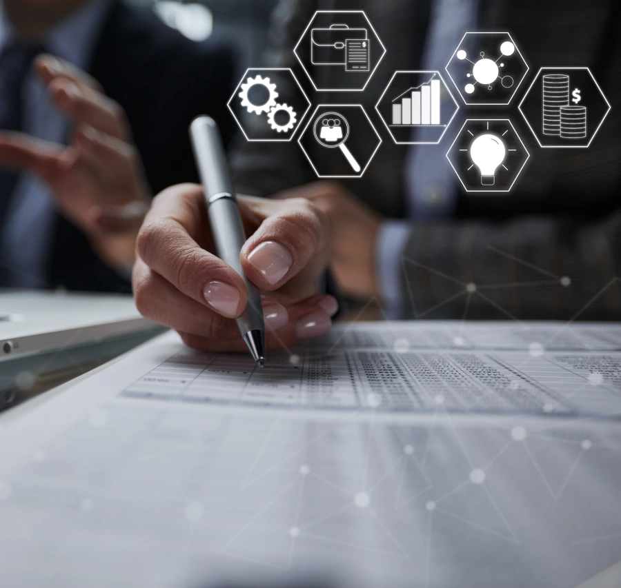 Close-up of hand writing on paper with digital transformation and analytics icons floating above document.